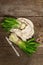 Bunches of fresh harvest of spring ramson, wild leek. Fragrant spicy leaves on vintage wooden table