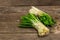 Bunches of fresh harvest of spring ramson, wild leek. Fragrant spicy leaves on vintage wooden table