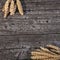 Bunches of golden wheat on wood