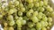 Bunches of grapes in the morning sun, green grapes close-up in a bowl filed to the table