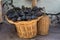 Bunches of red grapes in a wicker basket and carboy.