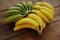 Bunches of tasty bananas on wooden table