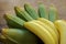 Bunches of tasty bananas on wooden table, closeup