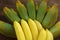 Bunches of tasty bananas on wooden table, closeup