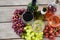 Bunches of various grapes with wine glass and bottles