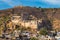 Bundi cityscape, travel destination in Rajasthan, India. The majestic fort perched on mountain slope overlooking the blue city.