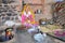 BUNDI, RAJASTHAN, INDIA - DECEMBER 09, 2017: Portrait of a beautiful young woman preparing chapati flat bread in the courtyard o