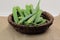 A bundle of fresh Lady& x27;s finger or Okra on wooden background with copy space