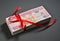 Bundle of Hundred Dirham notes tied up with red ribbon.