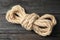 Bundle of natural hemp rope on wooden background