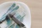 Bundle Russian money and cutlery is on the plate on a wooden table. Place for text, copyspace