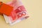 A bundle of Yuan or renminbi notes in an orange clip