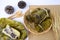 bundled boiled rice banana and sticky rice wrapped in banana leaves and black bean paste on bamboo baskets on background.Thai food