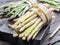 Bundles of green and white asparagus on wooden board. Organic food