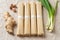 Bundles of raw udon noodles and spices closeup. Bunches of dried japanese vegan pasta from wheat flour, scallion, ginger and