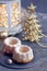 Bundt cakes on dark rustic table with Christmas lights in lantern and sparkling golden decorations