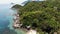 Bungalows and green coconut palms on tropical beach. Cottages on sandy shore of diving and snorkeling resort on Koh Tao