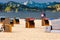 Bungalows sun protection on the beach for rent in summer holiday and snowy mountains in the background