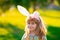 Bunny child boy face. Easter bunny children. Kids boy in bunny ears in park outdoor.