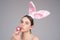 Bunny girl with easter egg. Rabbit girl with color egg. Woman in rabbit ears. Egg hunt.