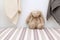 Bunny rabbit stuffed animal sitting on a shelf in a baby`s room