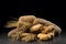 Buns, baguette, ciabatta and bread on dark wooden table. Rye, barley, wheat, oats and many fresh mixed breads on black ba