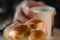 Buns and cup of fruit tea on white wooden table. man hands making tea, stirring slowly with spoon. delicious nourishing breakfast