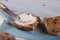 Buns of flour with bran with butter on a wooden table, top view