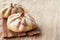 Buns of rye flour lie on a light wooden background. Mexican day of dead bread, pan de Muerto