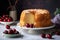 a bunt cake with a slice cut out of it and cherries on a plate next to it and a bowl of cherries in the background