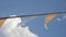 Bunting festive flags against blue sky and white fluffy clouds