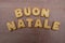 Buon Natale, italian Merry Christmas text composed with biscuit letters over a wooden table