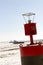 Buoy with The Crib and lighthouses on pier along shipping channel on frozen Lake Superior in Duluth, Minnesota