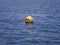 A buoy floating on blue ocean water