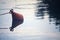 Buoy floating on the water and its reflection casted below it