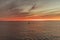 A buoy guards the entrace to a bay within a sunset in Cape Cod, Massachusetts