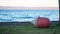 Buoy lying on the dry ground with lake and mountains as background