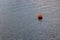 Buoy on a quiet water surface