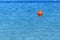 Buoy at right side on blue ocean like emergency sign