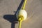 Buoy on a yellow rope lying on the wet sand