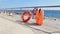 Buoyancy equipment for rescuing drowning people on the seashore. Lifebuoy and life jacket on the beach
