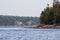 Buoys floating on Frenchman bay with island trees in the background