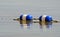 Buoys strung together and floating on surface of water