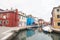 Burano Island, colored architecture, canal and boats. Trip to the island of Venice