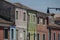 BURANO, ITALY - APRIL 18, 2009: Street with colorful buildings in Burano island, a gracious little town full of canals, near Venic