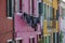 BURANO, ITALY - APRIL 18, 2009: Street with colorful buildings in Burano island, a gracious little town full of canals, near Venic