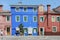 BURANO, ITALY - APRIL 18, 2009: Street with colorful buildings in Burano island, a gracious little town full of canals, near Venic