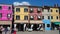 Burano, Venezia, Italy. Street with colorful houses in Burano island during a weekend with a lot of tourists