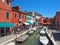 Burano, Venezia, Italy. Street with colorful houses in Burano island during a weekend with a lot of tourists