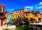 BURANO VENICE, ITALY - SEPTEMBER 19. 2018 - View on facade of famous fancy painted colorful houses